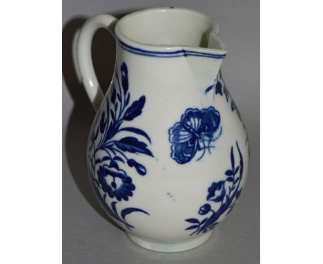 AN 18TH CENTURY WORCESTER SPARROW BEAK JUG, decorated with a rose, other flowers and a butterfly in blue under-glaze.