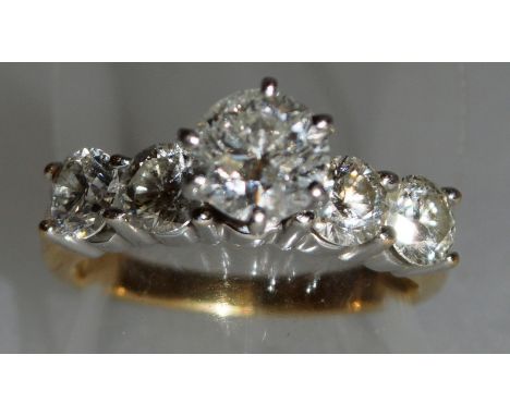 A FIVE STONE DIAMOND RING with large stone and approx. two diamonds to each shoulder.