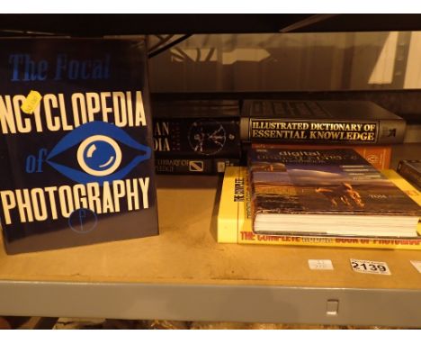 Shelf of photography related books and encyclopedias including digital photographers handbook