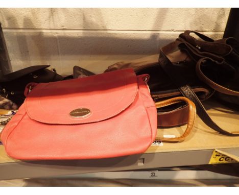 Shelf of ladies handbags purses etc