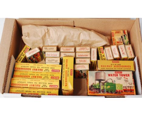 A small box of Merit boxed accessories with 7x gauge I lead figures, a lead Nestles chocolates vending machine, gauge II/III 