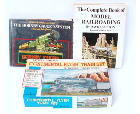 A small tray containing The Complete Book of Model Railroading by David Sutton (G), The Hornby Gauge 0 system by Chris & Juli