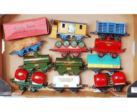 A large tray of mainly prewar Hornby wagons including snow plough (F) fibre wagon (VG-BG), barrel wagon (G), No. 1 milk traff