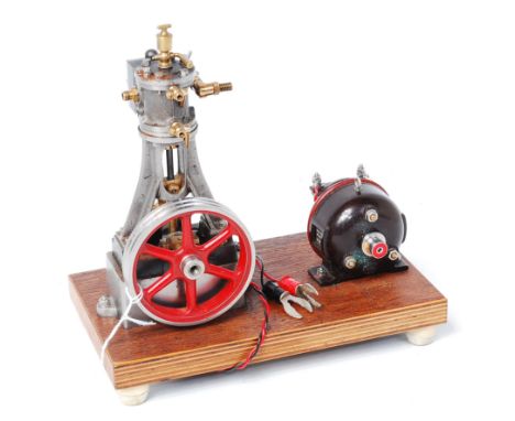 Stuart No. 10v vertical engine with 6 spoke, twin grooved, 3 inch flywheel on wood base with dynamo fitted, made by Roy Grego