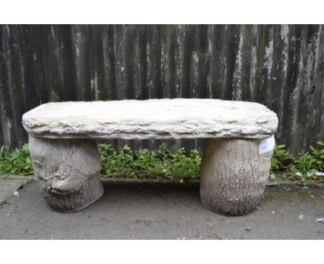 Garden ornaments - a reconstituted stone bench, simulated bark seat, tree trunk supports.