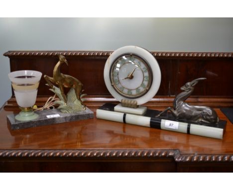A French Art Deco slate and onyx mantel clock, gilt brass mounted circular dial, Arabic numerals, the rectangular base applie