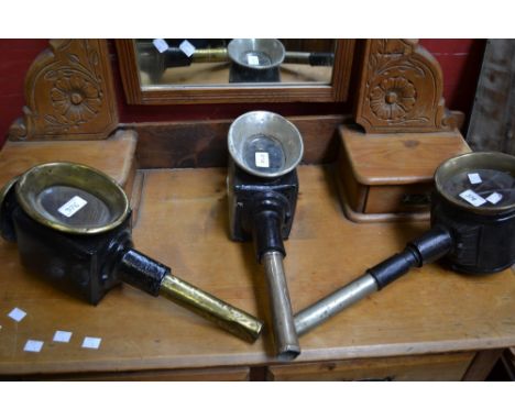 A 19th century brass and black painted coaching lamp, 45cm high; others, similar (3) 