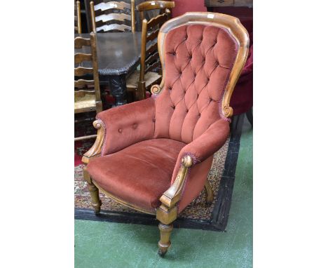 A Victorian button back armchair, scroll arms, ceramic casters C1860