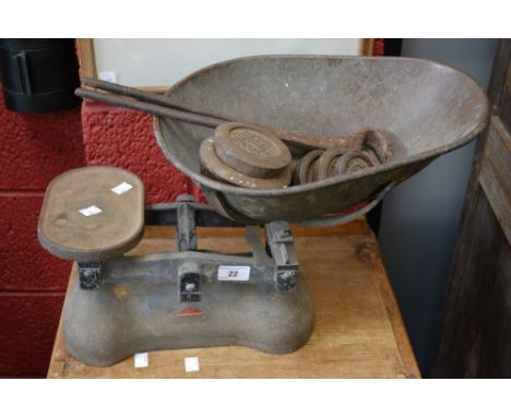A large pair of kitchen scales, light iron weights en suite; (3)