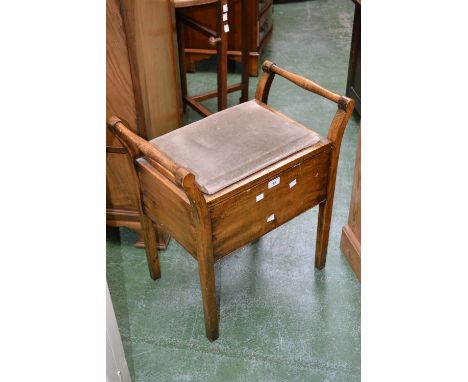 An oak piano stool, turned side rails, padded hinged seat.