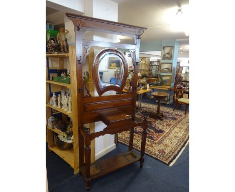 A mahogany hallstand with horseshoe style mirror