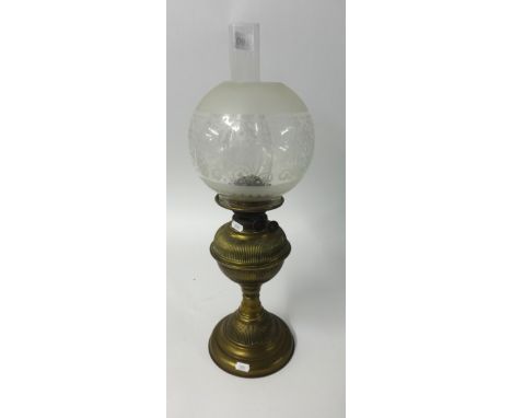 An antique brass oil lamp with etched globular shade and funnel, maximum height 54cm.
