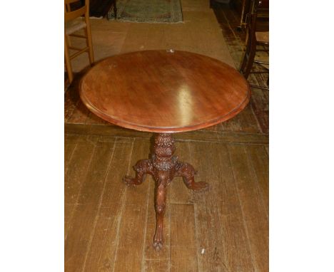 A mahogany circular occasional table, on a carved support and tripod base with paw feet, D 68cm.