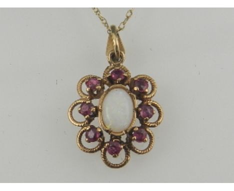 A yellow metal, ruby, and opal cluster pendant, suspended on a 9 carat yellow gold chain. 