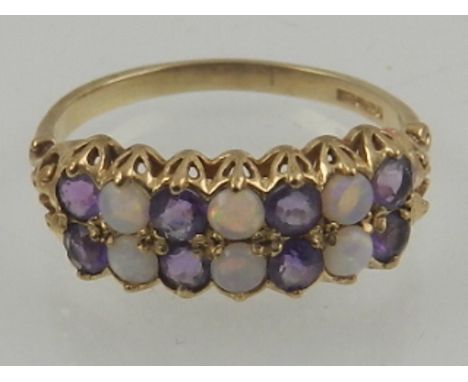 A 9 carat yellow gold, amethyst, and opal ring, set alternating rows of stones. 