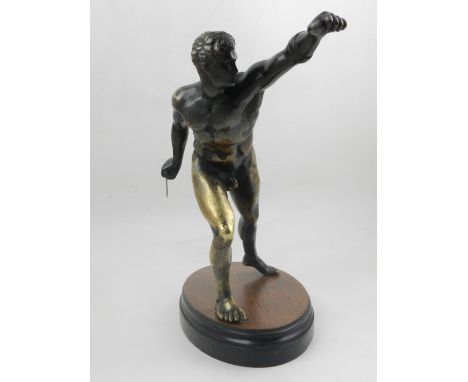 A 19th century bronze figural study of a Roman gladiator, raised on a later mahogany oval base. H: 24cm