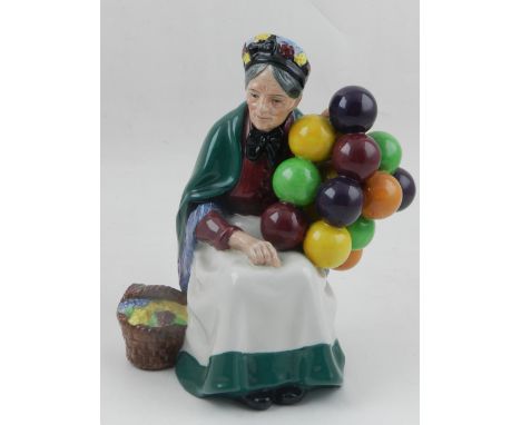 Royal Doulton, England. A ceramic model of a lady entitled 'The Old Balloon Seller'. H: 18cm 