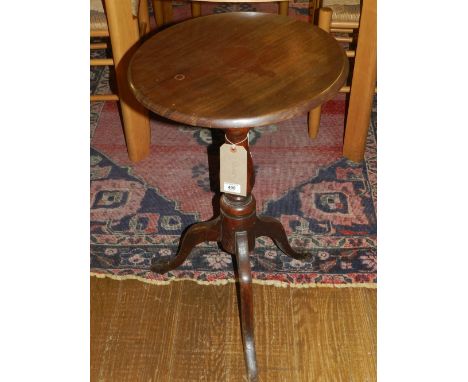 A 19th century mahogany circular tilt-top wine table, having turned column support, raised on tripod feet. D: 42cm