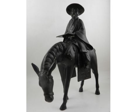 A 20th century Chinese bronze figural group of a gentleman riding a horse. H: 44cm
