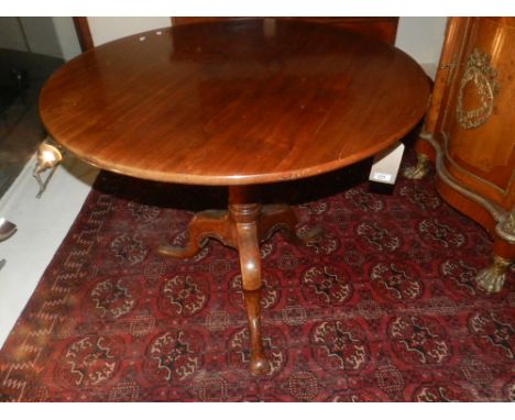 A George III mahogany circular tilt-top table, raised on reeded column support and cabriole tripod legs. H: 70cm D: 88cm