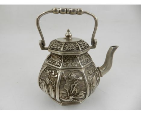 A Chinese white metal teapot, swing handled, decorated with panels of birds, fishes and foliage, bears six character mark to 