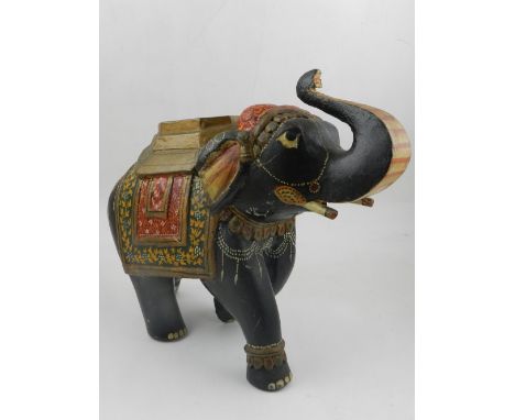 A 20th century hardwood model of an elephant, hand-painted with floral detail, together with a hardwood model of a duck, and 