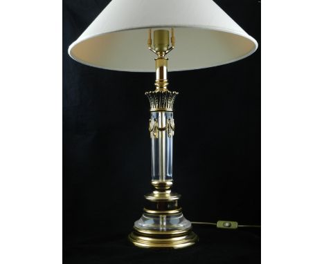 A contemporary perspex and gilt metal mounted table lamp, of Corinthian column form, raised on a circular base. H: 45cm