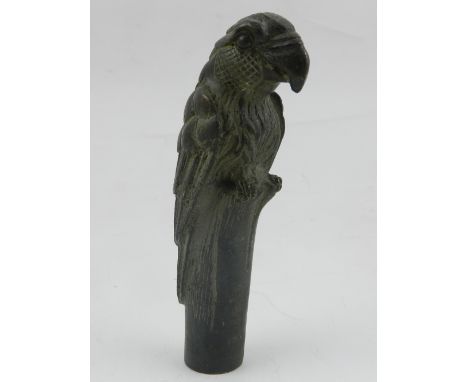 A bronze walking stick topper in the form of a parrot.