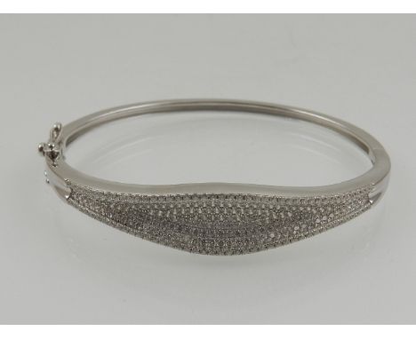 A silver and cubic zirconia set bangle bracelet.