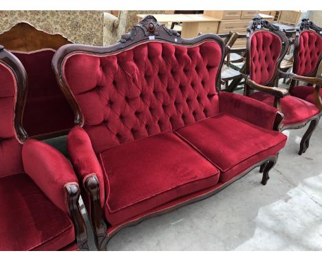 A FRENCH STYLE CARVED WOODEN AND RED BUTTON BACK UPHOLSTERED TWO SEATER SOFA 