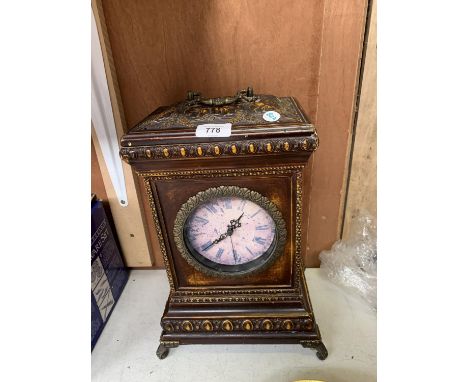 A WOODEN MANTEL CLOCK 