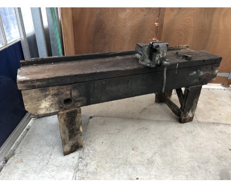 A VINTAGE PINE WORK BENCH WITH LARGE BENCH VICE 