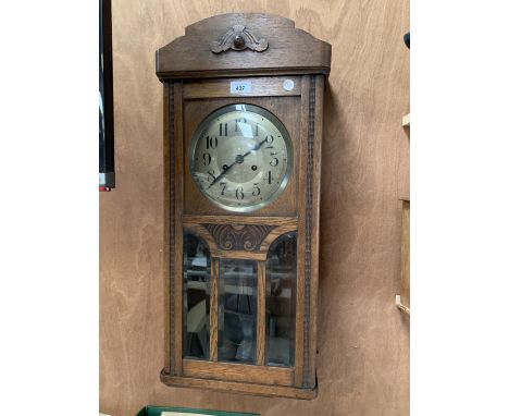 A WOODEN WALL CLOCK WITH GLASS CASING 