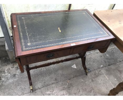 A MAHOGANY DROP END SOFA TABLE WITH BRASS FEET AND CASTERS AND GREEN LEATHER WRITING SURFACE 