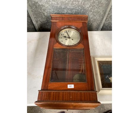 A WOODEN WALL CLOCK WITH GLASS WINDOW 