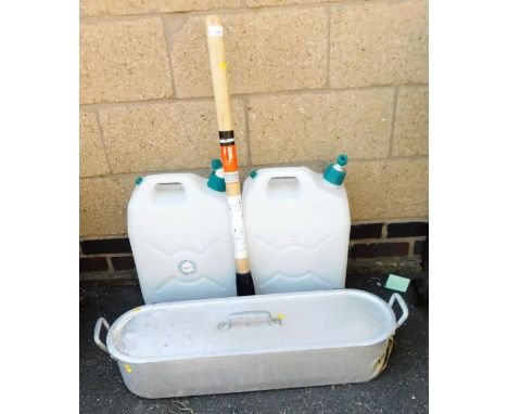 Two large plastic Jerry cans, pick axe and a fish kettle.