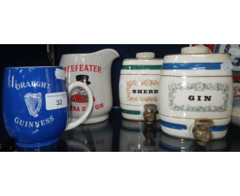 A Carlton ware "Draught Guinness" blue glazed mug, a Beefeater Wade jug and two spirit ceramic miniature barrels 