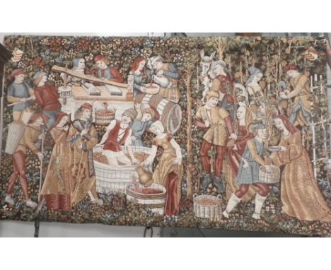 A large wall hanging tapestry depicting grape harvesting