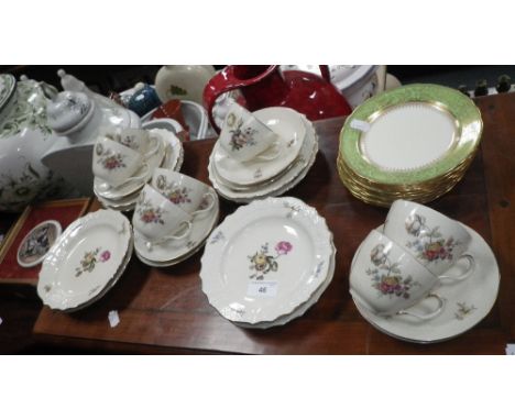 A quantity of Royal Copenhagen tea ware decorated with flowers and a collection of green and gilt tea plates