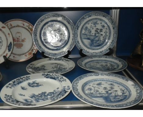 Six Chinese blue and white plates, three decorated with bamboo beside a garden wall (5)