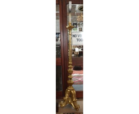 A carved gilt standard lamp in the form of a large Baroque candlestick