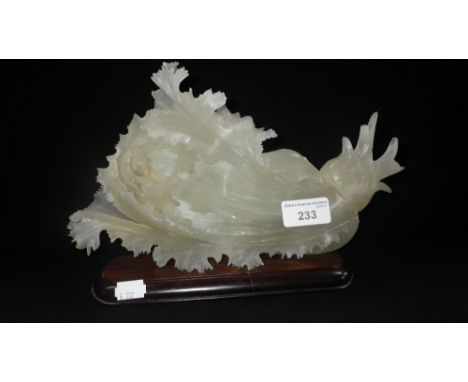 A carved 'Jade' leaf-form sculpture