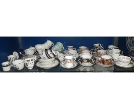 A large collection of early 19th century and similar cups and saucers