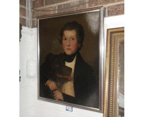 A naive19th century oil on board portrait of a boy with his dog