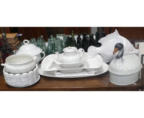 A white glazed ceramic study of a fish and a collection of similar ceramics