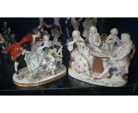 A ceramic group of figures playing cards and another similar