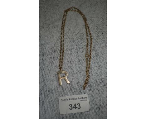 A 9ct yellow gold pendant modelled as the letter 'R' on a 9ct yellow gold belcher link chain