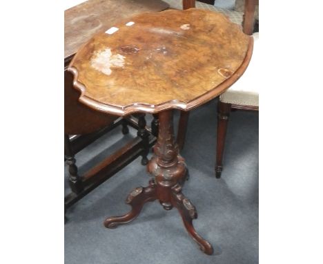 A Victorian walnut tripod table with carved base