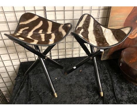 PAIR OF ZIMMERMAN STYLE SAFARI ZEBRA SKIN &amp; EBONISED WOOD CAMPAIGN FOLDING TRIPOD STOOLS
