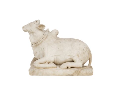 A CARVED MARBLE SCULPTURE OF NANDI THE BULL India, 19th centuryA finely carved white marble figure of Nandi, the sacred bull 
